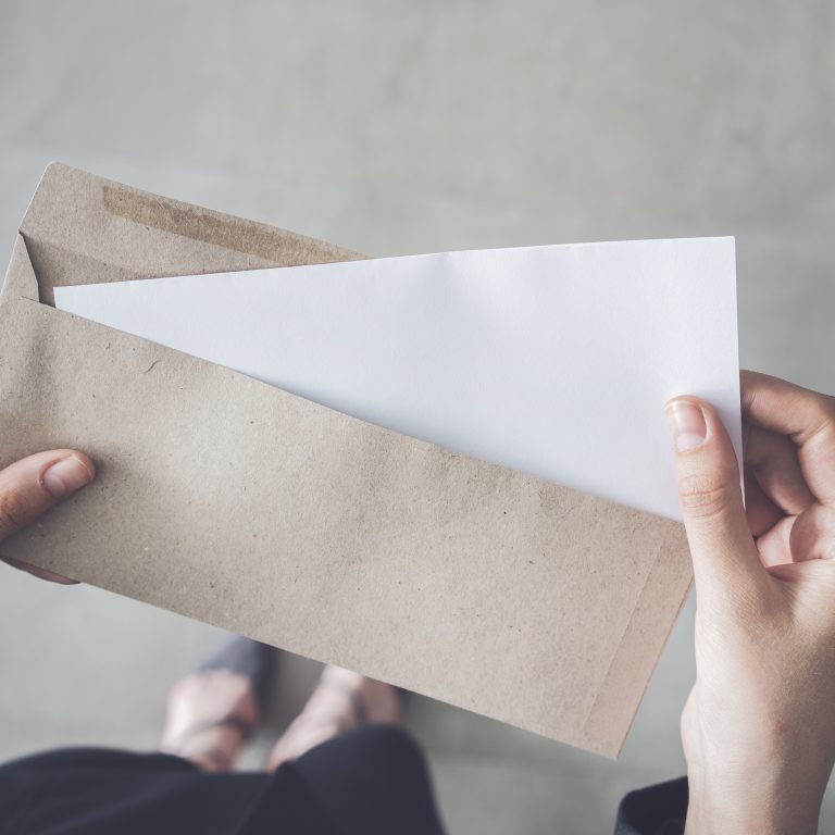 Letter being put in an envelope by shareholder to vote by proxy