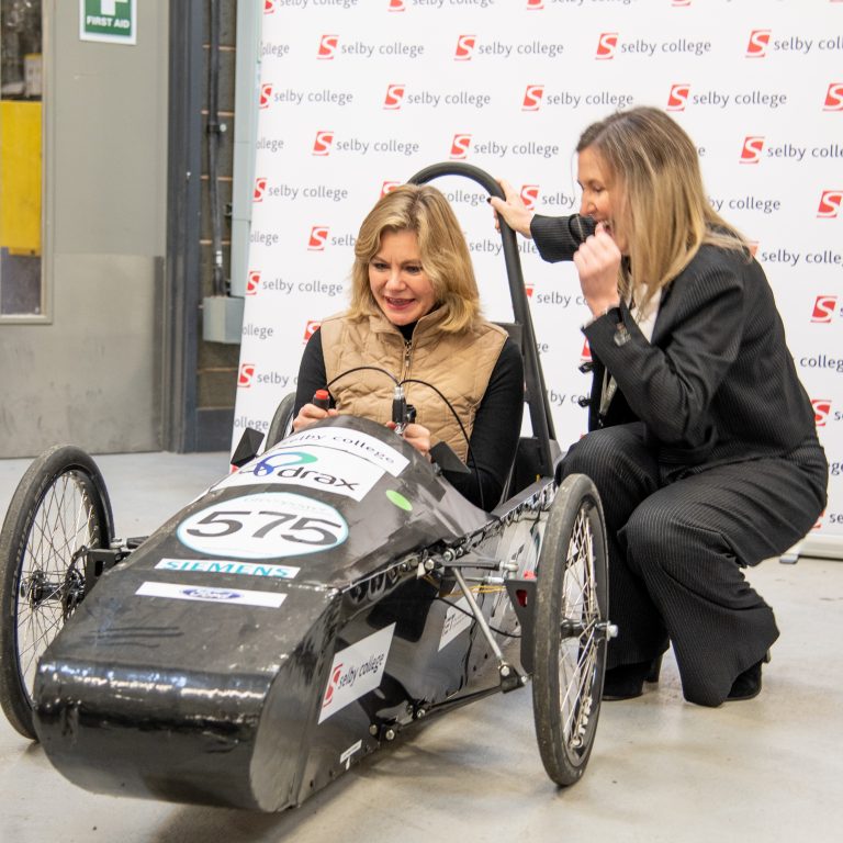 Justine Greening at Selby College in electric car